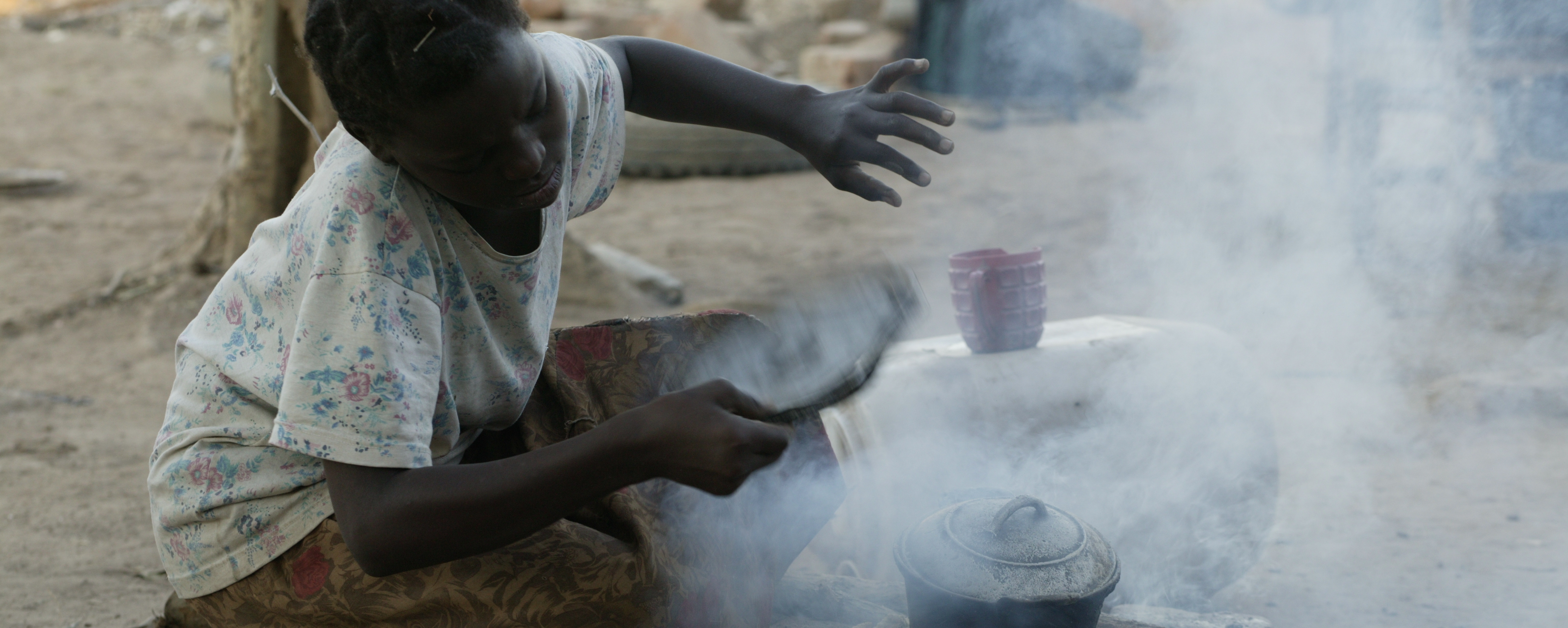 Woman cooking on traditional outdoor stove